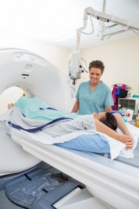 Nurse Looking At Patient About To Undergo CT Scan